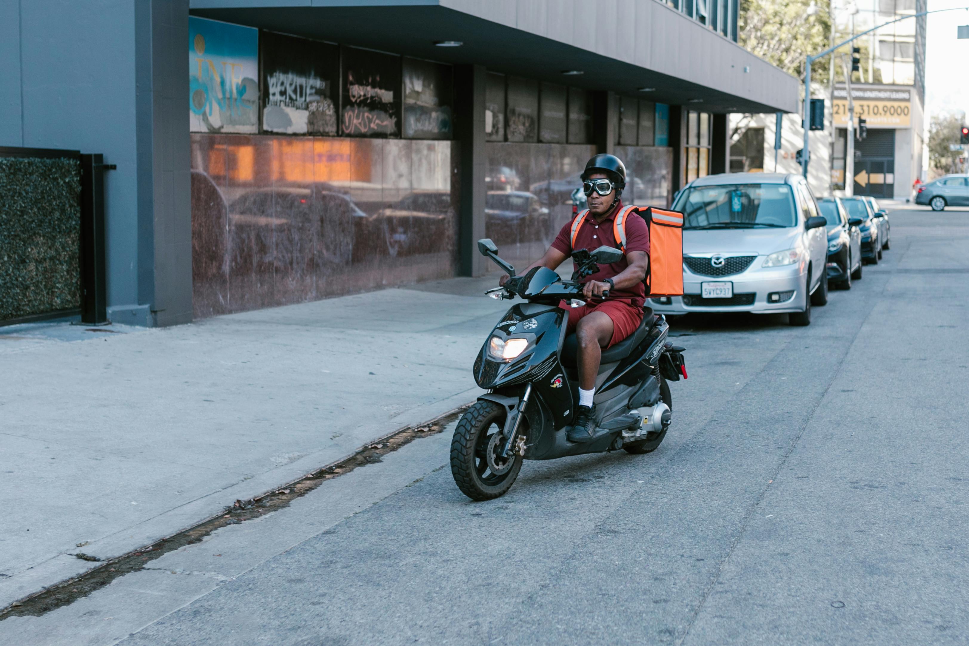 Dispatch rider delivering a package on a motorbike